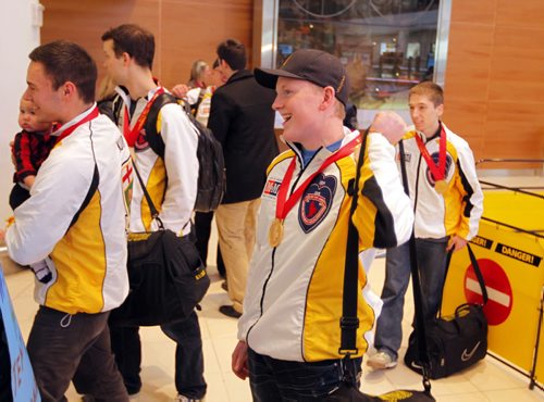 SPORTS - CURLING - Team Manitoba, Canadian champs arrive home. Skip Braden Calvert, centre front, leads the team to the awaiting fans and family at the the airport. BORIS MINKEVICH / WINNIPEG FREE PRESS  FEB 2, 2015