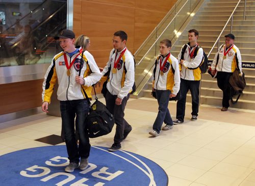 SPORTS - CURLING - Team Manitoba, Canadian champs arrive home. Skip Braden Calvert leads the team: third Kyle Kurz, second Lucas Van Den Bosch, and  lead Brendan Wilson, and coach Tom Clasper down the stairs at the the airport. BORIS MINKEVICH / WINNIPEG FREE PRESS  FEB 2, 2015