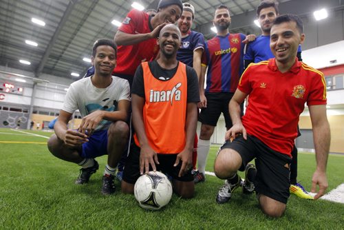 LOCAL - Newcomer men who meet every Friday night to play soccer and hang out with the guys so theyre not as isolated and stressed. Muuxi Adam, with orange tank top piny,  is a community development worker with the Aurora Family Therapy Centre who runs the program. BORIS MINKEVICH / WINNIPEG FREE PRESS  JAN. 30, 2015