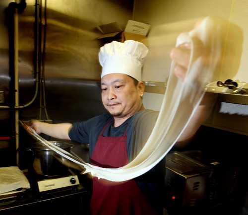 Jun Yang, co-owner and chef at the Golden Loong stretches then "rips" noodles preparing a favorite dish "hot spicy pork with hand-ripped noodles". See Marion Warhaft's review. February 3, 2015 - (Phil Hossack / Winnipeg Free Press)
