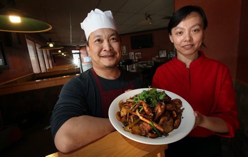 Jun Yang, and his wife Kelly Wu co-owners of the Golden Loong show off "Sauteed Chicken in Iron Wok". See Marion Warhaft's review. February 3, 2015 - (Phil Hossack / Winnipeg Free Press)
