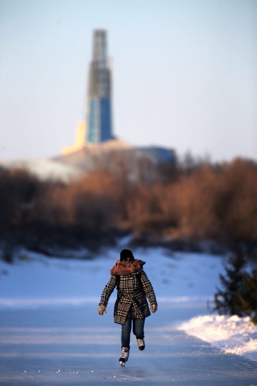 With the Canadian Museum for Human Rights in the background, Brittany Dreger, 22, skates along the River Trail on the Red River along Lyndale Drive, Wednesday, February 4, 2015. (TREVOR HAGAN/WINNIPEG FREE PRESS)