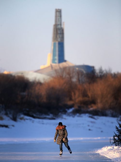 With the Canadian Museum for Human Rights in the background, Brittany Dreger, 22, skates along the River Trail on the Red River along Lyndale Drive, Wednesday, February 4, 2015. (TREVOR HAGAN/WINNIPEG FREE PRESS)