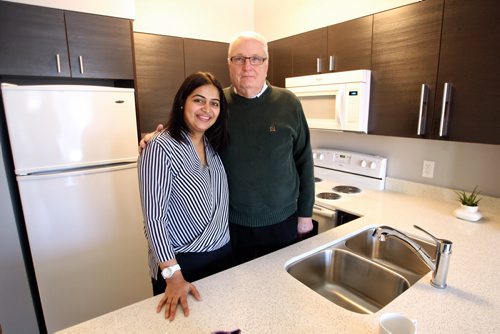 Hijab Mitra from Mistecture Architecture and the developer Robert Dick CEO of Hargrave Holdings in the kitchen of one of the apartments at Marie Rose Place 207 Edmonton St a new six-storey building thatÄôs now open and provides supportive housing for immigrant and refugee women. 150205 February 05, 2015 Mike Deal / Winnipeg Free Press