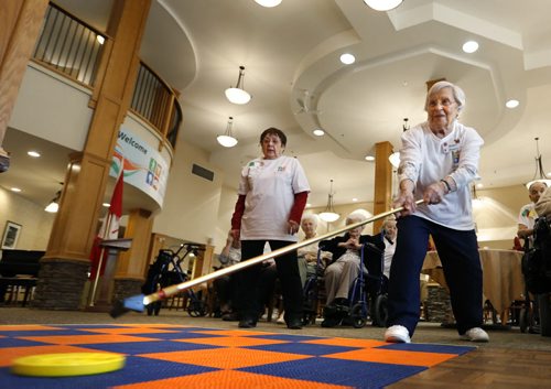 Bianca Blanaru lets a disc fly during a shuffleboard game against Margaret Penner at the Shaftesbury Park Retirement Residence Thursday during the Annual ASC Seniors Games. Thousands of residents from 20 All Seniors Care Living Centres Retirement Residences across Canada are taking part getting active in the friendly competition.  Participates will be walking, "Wii-ing", playing bocce, billiards and board games, the events also includes an awards ceremony and special guests.   see email release for info.  Wayne Glowacki/Winnipeg Free Press Feb.5  2015