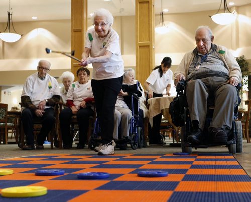 Roslyn Silver lets a disc fly during a shuffleboard game against Irv Sera at the Shaftesbury Park Retirement Residence Thursday during the Annual ASC Seniors Games. Thousands of residents from 20 All Seniors Care Living Centres Retirement Residences across Canada are taking part getting active in the friendly competition.  Participates will be walking, "Wii-ing", playing bocce, billiards and board games, the events also includes an awards ceremony and special guests.   see email release for info.  Wayne Glowacki/Winnipeg Free Press Feb.5  2015