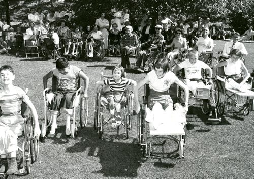Merrymenders first annual picnic behind Princess Elizabeth attended by 87 polio, arthritic, diabetic and rheumatic patients. Pic shows wheel chair race for 10-14 year olds. Winnipeg Free Press 1955