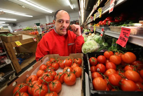 Munther Zeid, owner of FoodFare on Portage Ave. works  in his produce department where some items like tomatoes and cabbage have gone up in price due to low Canadian dollar.   See story.   Feb 05, 2015 Ruth Bonneville / Winnipeg Free Press