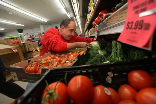 Munther Zeid, owner of FoodFare on Portage Ave. works  in his produce department where some items like tomatoes and cabbage have gone up in price due to low Canadian dollar.   See story.   Feb 05, 2015 Ruth Bonneville / Winnipeg Free Press