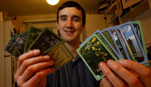 Trevor Lehmann, with cards from the board game he developed, Crop Cycle, Thursday, February 5, 2015. (TREVOR HAGAN/WINNIPEG FREE PRESS)