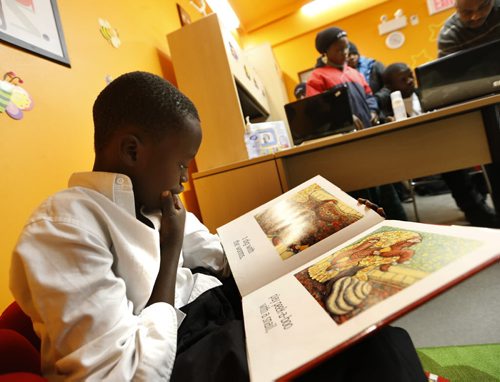 Minutes after the ribbon cutting ceremony to open the Masoud Moradi Children's Library in the Welcome Place, Mohamed Sesay settled into a book. The space will also offer reading, writing and spelling programs and has computer workstations. The library is for newly-arrived refugees in Welcome Place, the largest resettlement agency in Manitoba. The library was named after a longtime co-worker and friend to many at the Welcome Place who passed away.  Wayne Glowacki/Winnipeg Free Press Feb.6  2015