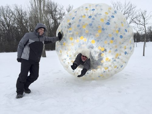 Rich Hince, owner of Games2U Winnipeg, poses with Free Press columnist Doug Speirs, in a life-sized clear plastic Hamster Ball, at Assiniboine Park. February 6, 2015