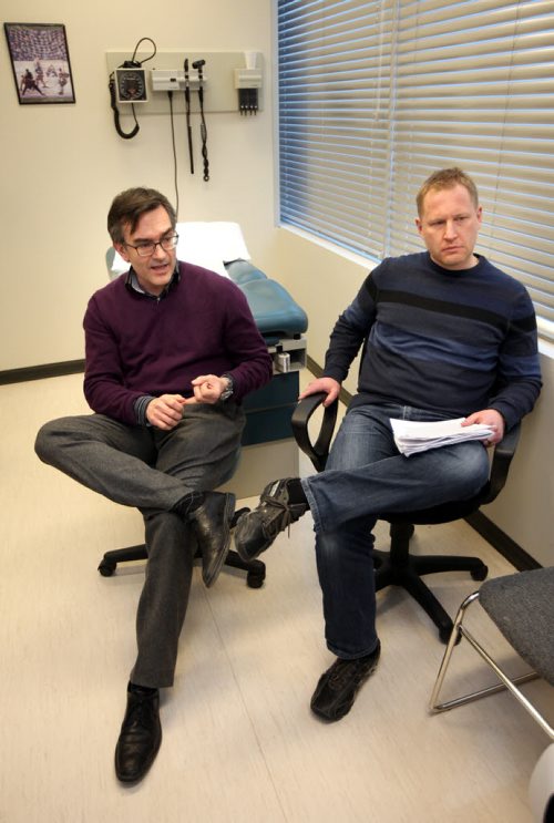 Disgruntled doctors, Dr. Florin Padeanu (left) and Dr. Terry Szajkowski talk with Larry Kusch Friday afternoon at their clinic. Theyre angry with the College of Physicians new on-call policy. See story. February 6, 2015 - (Phil Hossack / Winnipeg Free Press)