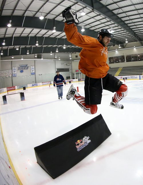 A participant jumps over an obstacle as he participates in the Red Bull Crashed Ice qualifiers at the MTS Iceplex, Saturday, February 7, 2015. (TREVOR HAGAN/WINNIPEG FREE PRESS)