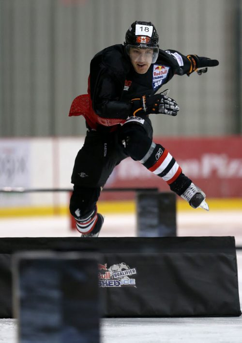 Eric Milinkovic jumps over an obstacle as he participates in the Red Bull Crashed Ice qualifiers at the MTS Iceplex, Saturday, February 7, 2015. (TREVOR HAGAN/WINNIPEG FREE PRESS)