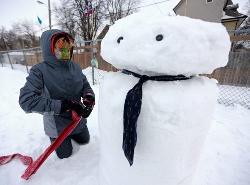 Cezyn Sinclair, 10, decorates a snowman at the West Broadway Snoball, Saturday, February 7, 2015. (TREVOR HAGAN/WINNIPEG FREE PRESS)