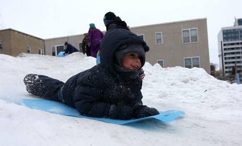 Harrison Brooks, 4, slides down a small snow hill at the West Broadway Snoball, Saturday, February 7, 2015. (TREVOR HAGAN/WINNIPEG FREE PRESS)