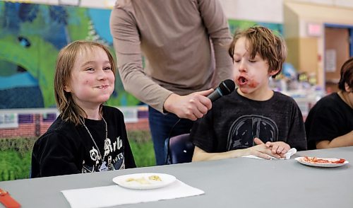 Westley Delaney, 8 (left), has a hard time keeping a straight face while Jackson Gilmore, 10 (right) yells into the mic that he is done during the pie eating contest at the Winter Festival at R. A. Steen Community Centre Sunday afternoon.  150208 February 08, 2015 Mike Deal / Winnipeg Free Press