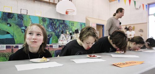 Westley Delaney, 8 (left), has a hard time keeping a straight face during the pie eating contest at the Winter Festival at R. A. Steen Community Centre Sunday afternoon.  150208 February 08, 2015 Mike Deal / Winnipeg Free Press