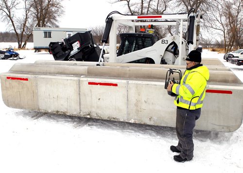 STANDUP - Ice cutting machines are marshalling at the End of Main at Netley Creek, north of Selkirk, Manitoba. In photo Ray Cobert of North Red Waterways Maintenance Corp. holds a remote control for the cutting unit. When they cut the operator will be in an amphibious Argo a safe distance away from the actual cutting. The crew will cut for 4-6 weeks and then the Amphibex ice breakers will move in to open up the waterway. BORIS MINKEVICH / WINNIPEG FREE PRESS  FEB. 9, 2015
