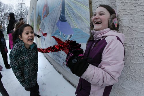 February 9, 2015 - 150209  -  Anaisha Boucher, Iliyana Kaschor (R), other Art City participants and families unveiled the We [heart] Winnipeg mural during a ribbon cutting ceremony at 595 Broadway Monday, February 9, 2015. Eighty young artists and guest artist Ildiko Nova painted the 3-piece mural featuring some of our favourite Winnipeg landmarks (like the Legislative Building, Thunderbird House, the Winnipeg Art Gallery, MTS Centre, and more!), and Manitoba wildlife, through the seasons. John Woods / Winnipeg Free Press