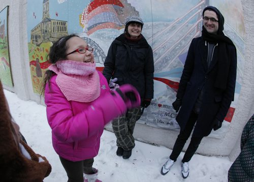 February 9, 2015 - 150209  -  Sara Murdock gets excited after Ildiko Nova (c) and Josh Ruth, Managing Director of Art City, cut a ribbon to  unveil the We [heart] Winnipeg mural during a ribbon cutting ceremony at 595 Broadway Monday, February 9, 2015. Eighty young artists and guest artist Ildiko Nova painted the 3-piece mural featuring some of our favourite Winnipeg landmarks (like the Legislative Building, Thunderbird House, the Winnipeg Art Gallery, MTS Centre, and more!), and Manitoba wildlife, through the seasons. John Woods / Winnipeg Free Press