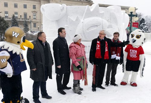 Premier Greg Selinger with from left Buzz, Wade Miller, pres. and CEO of the Winnipeg Blue Bombers, Jason Smith with the Blue Bombers and pres. of the103rd Grey Cup Festival, Ginette Lavack-Walters, Ex.Dir. of the Festival du Voyageur, Chad Falk, G.M., Venues, 2015 FIFA Women's World Cup and Shuéme by the snow sculpture in front of the Manitoba Legislative Bld. that captures the up coming events.   Wayne Glowacki/Winnipeg Free Press Feb.10   2015