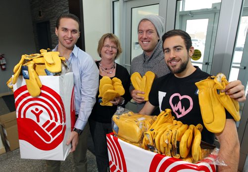 STANDUP - Delivery of new garbage mitts for United Way's Koats for Kids program. (L-R) Benjamin Nasberg, managing partner at Carbone Pizza, Donna Albak, program manager for Koats for Kids, Michael Nugent fiend of Carbone Pizza that donated 100 pairs of mitts, and Joe Paletta chef and managing partner Carbone Pizza. (from UW web) Koats for Kids has been a Winnipeg institution since 1989. Every year, from October to February, the program distributes winter outerwear to families  for some children, having a warm coat means attending school on a cold day, instead of staying home. Its part of United Ways commitment to helping children and youth be all they can be. Photo taken at the United Way office at 580 Main Street. BORIS MINKEVICH / WINNIPEG FREE PRESS  FEB. 10, 2015
