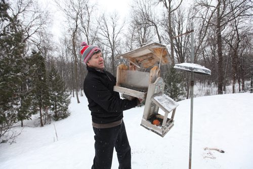 Bird watching enthusiast Paul Buchanan, sets up his bird feeders while listening and watching for birds in his yard where often spots various many species of birds.  See Ashley Prest story.  Feb 10, 2015 Ruth Bonneville / Winnipeg Free Press