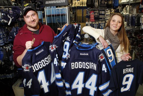 SPORTS - Royal Sports employees Casey Bresch and Taylor Keane pose with some Zach Bogosian and Evander Kane wear that is coincidently on sale at the Pembina Highway store. BORIS MINKEVICH / WINNIPEG FREE PRESS  FEB. 11, 2015