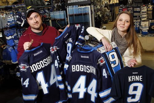 SPORTS - Royal Sports employees Casey Bresch and Taylor Keane pose with some Zach Bogosian and Evander Kane wear that is coincidently on sale at the Pembina Highway store. BORIS MINKEVICH / WINNIPEG FREE PRESS  FEB. 11, 2015