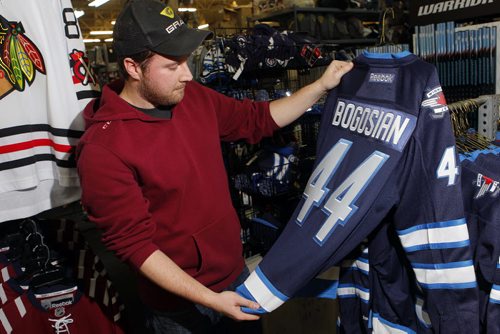 SPORTS - Royal Sports employee Casey Bresch with some Zach Bogosian and Evander Kane wear that is coincidently on sale at the Pembina Highway store. BORIS MINKEVICH / WINNIPEG FREE PRESS  FEB. 11, 2015