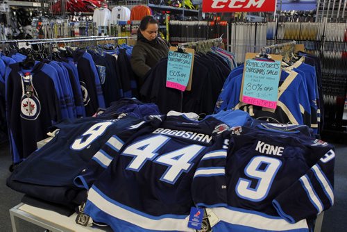 SPORTS - Royal Sports. An unidentified shopper looks through some Zach Bogosian and Evander Kane wear that is coincidently on sale at the Pembina Highway store. She said that Bogosian was her favourite player since the start. She didn't want to give her name since she was looking for a surprise valentines gift for her boyfriend. BORIS MINKEVICH / WINNIPEG FREE PRESS  FEB. 11, 2015