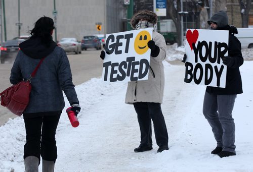 As part of Sexual & Reproductive Health Awareness Week which runs February 9-13, Sexuality Education Resource Centre (SERC)  -Melanie Saindom, right and  Ann Singbeil and use message boards on York Ave this morning in an effort to promote pleasurable and sex positive safer sexual health messages Standup Photo- Feb 12, 2015   (JOE BRYKSA / WINNIPEG FREE PRESS)