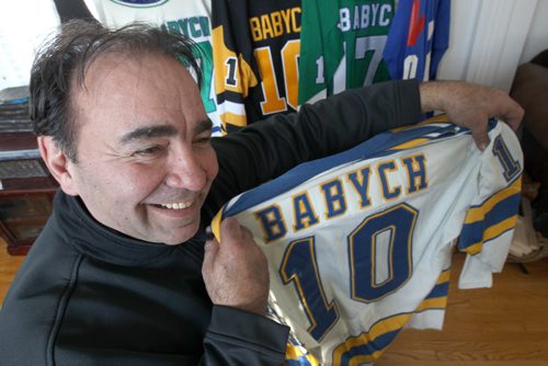 Wayne Babych a former NHL hockey player with his son Cole- He comments on how big trades effect team and hold one of his old St Louis Blues Jerseys -See Geoff Kirybson story  - Feb 13, 2015   (JOE BRYKSA / WINNIPEG FREE PRESS)
