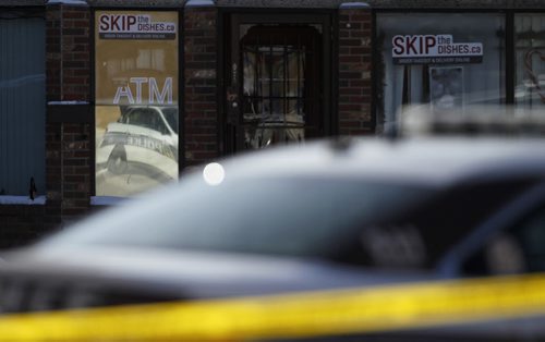 Police car reflecting off the window of the Blue Nile at the scene of a stabbing on Sargent Avenue at Young Street, Saturday, February 14, 2015. (TREVOR HAGAN/WINNIPEG FREE PRESS)