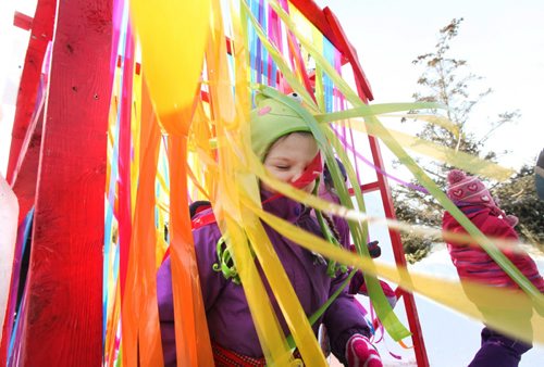 Kids love passing through layers of multi-coloured fun strips of plastic while making their way into the children's play area at The Festival du Voyageur  Saturday.  Feb 14, 2015 Ruth Bonneville / Winnipeg Free Press