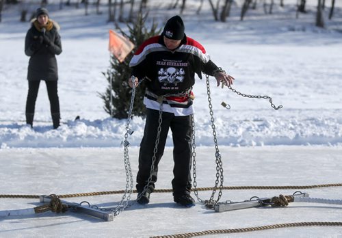 Escape artist, Dean Gunnarson works on escaping from locks and chains during an escape between two zamboni's on the Red River near The Forks, Saturday, February 14, 2015. (TREVOR HAGAN/WINNIPEG FREE PRESS)