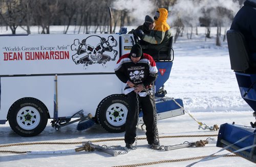 Zamboni's pass on both sides of escape artist, Dean Gunnarson, as he unlocks himself from chains during an escape on the Red River near The Forks, Saturday, February 14, 2015. (TREVOR HAGAN/WINNIPEG FREE PRESS)