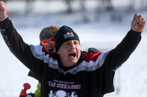 Escape artist, Dean Gunnarson celebrates after completing an escape where he was locked to a rope between two zamboni's on the Red River near The Forks, Saturday, February 14, 2015. (TREVOR HAGAN/WINNIPEG FREE PRESS)