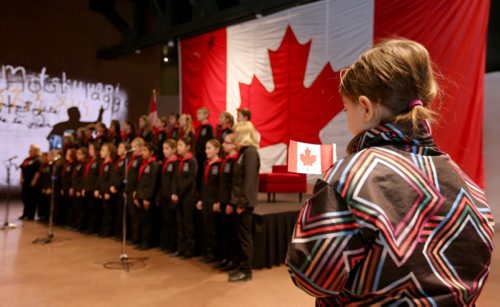 The Winnipeg Youth Choir performs "Oh Canada" during a flag raising event at the CMHR on the 50th anniversary of our current Canadian Flag, Sunday, February 15, 2015. (TREVOR HAGAN/WINNIPEG FREE PRESS)