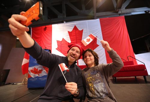 Ian McCausland and his son Liam take a selfie at the CMHR on the 50th anniversary of our current Canadian Flag, Sunday, February 15, 2015. (TREVOR HAGAN/WINNIPEG FREE PRESS)