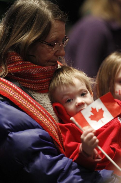 Griffin Valainis, 2, sits with his grandmother, Alison Baldwin, at the CMHR during a flag raising event on the 50th anniversary of our current Canadian Flag, Sunday, February 15, 2015. (TREVOR HAGAN/WINNIPEG FREE PRESS)