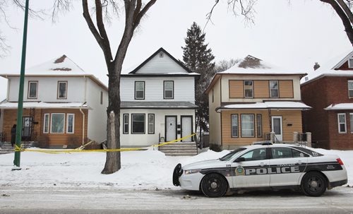 Police tape blocks off the duplex house at 313 Inkster Blvd. Monday morning after a man was shot Sunday evening. He was taken to hospital in critical condition. 150216 February 16, 2015 Mike Deal / Winnipeg Free Press