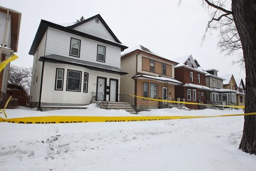 Police tape blocks off the duplex house at 313 Inkster Blvd. Monday morning after a man was shot Sunday evening. He was taken to hospital in critical condition. 150216 February 16, 2015 Mike Deal / Winnipeg Free Press