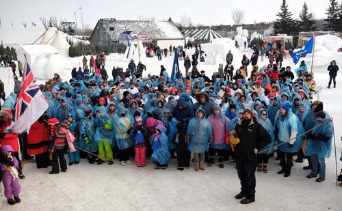 The crowd gathers together during the making of the largest living Métis flag ever on the grounds of the Festival du Voyageur Monday afternoon on Louis Riel Day.   150216 February 16, 2015 Mike Deal / Winnipeg Free Press