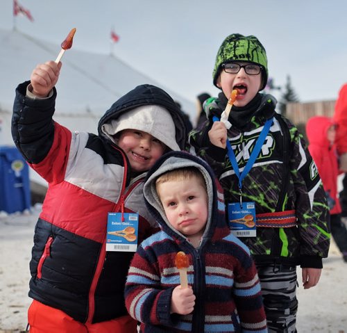 (Front to back) Grayson Lindsay, 2, Cole Lindsay, 6, and Paul Gill, 7, enjoy Maple Syrup on a Stick while at the Festival du Voyageur Monday afternoon on Louis Riel Day.  150216 February 16, 2015 Mike Deal / Winnipeg Free Press