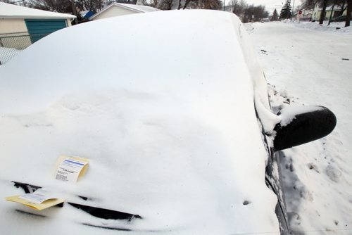 One of thousands of parking tickets- This one on Leo Novak St- the City Of Winnipeg wrote during this weekends residential parking banStandup Photo- Feb 17, 2015   (JOE BRYKSA / WINNIPEG FREE PRESS)