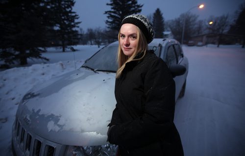 Katja MacMahon, poses with her car on the street in front of her Tuxedo home Tuesday. She normally parks in her driveway, parked on the street this weekend because her driveway was full. She didnt check for a parking ban, since she doesnt normally park on the street, and was ticketed. However the next morning the tow truck driver knocked on her door and let her move her car instead of towing it. See story.. February 17, 2015 - (Phil Hossack / Winipeg Free Press)