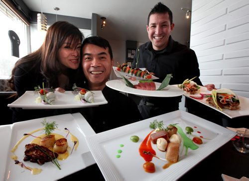 Fusian Experience, left to right Lisa and Chris Taing with Amos Ramon of Fusian Experience show off armloads of their specialities! See review. February 17, 2015 - (Phil Hossack / Winipeg Free Press)